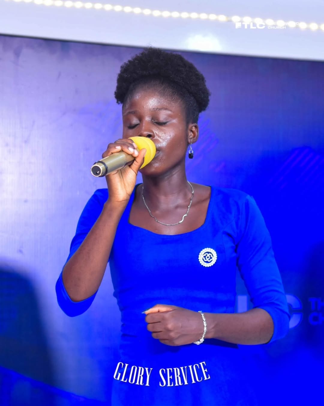 A worship leader singing during a LifeWord Church service